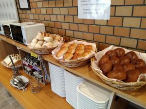 a counter with many baskets of bread on it at Hotel Axia Inn Kushiro - Vacation STAY 67230v in Irifunechō +23 photos
