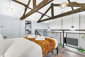 a bedroom with a large bed and a fireplace at Luxe NY Loft-Style - Central Birmingham - 2BR - Lush Green Oasis in Birmingham
