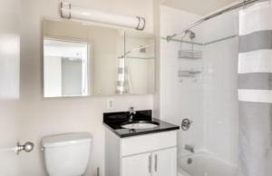 a bathroom with a toilet and a sink and a shower at The Urban Retreat 3BR Apartment in NYC! in New York