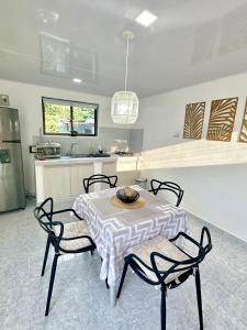 a kitchen with a table and four chairs and a kitchen at Posada Lkjay Providencia Isla in Providencia +53 photos