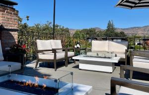a patio with two chairs and a fire pit at Maison Fleurie, A Four Sisters Inn in Yountville