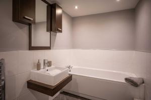 a bathroom with a sink and a bath tub at Regent House in Thirsk