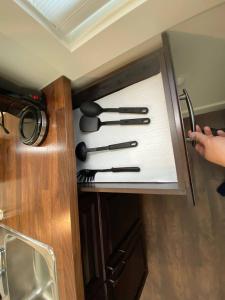 a drawer with knives in a cabinet in a kitchen at Brand New 1 Br 1 Bath Close To All Walkable in Edmonton