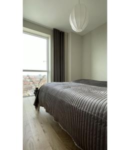 a bedroom with a bed and a large window at ApartmentInCopenhagen Apartment 1530 in Copenhagen