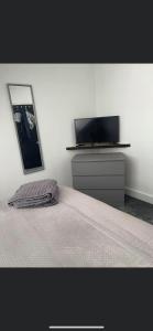 a bedroom with a bed and a flat screen tv at Bloww lodge in Oulton