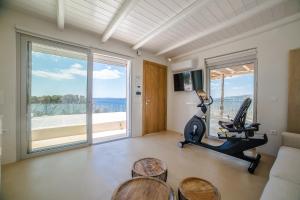 a living room with a couch and a gym at Seafront Athens Riviera Lagonisi Villa in Lagonissi