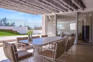 a dining room with a table and chairs at Seafront Athens Riviera Lagonisi Villa in Lagonissi