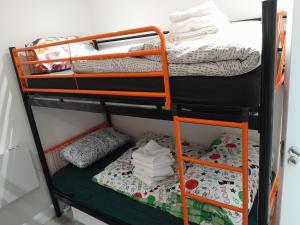 a bunk bed with a green bottom bunk at ND'S APARTMENT in Phibblestown