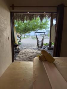 a room with a hammock and a view of a beach at Casa Gitana -Only Adults- in Guayabas
