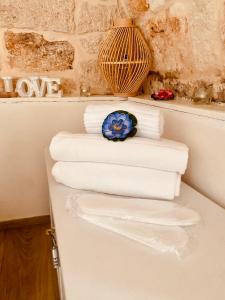 a stack of towels sitting on a counter in a bathroom at Stella Marina Luxury in Polignano a Mare
