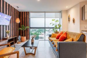 a living room with a couch and a large window at Amazing view with RoofGarden in Guadalajara