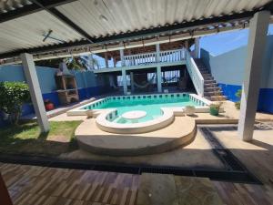 a swimming pool in front of a house at Hostal mar in Sonsonate