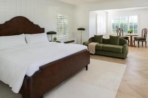 a bedroom with a large bed and a couch at The Inn at Rancho Santa Fe in Rancho Santa Fe