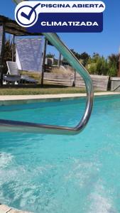 a swimming pool with a water slide in the water at Apartamentos La Playa in Piriápolis