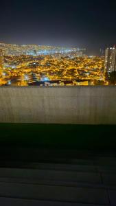 a view of a city at night with at Departamento nuevo 1D1B estacionamiento privado gratis in Viña del Mar