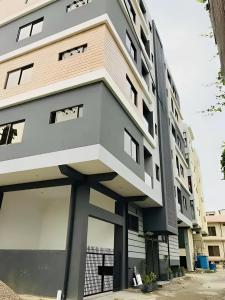 a building with large windows on the side of it at 2 Bedrooms Deluxe Family Apartment Islamabad-HS Apartments in Islamabad