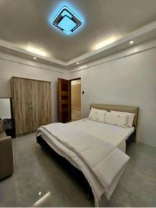 a bedroom with a large bed with a light on the ceiling at Mountain View in Binangonan