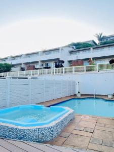 a large swimming pool in front of a building at Illovo Beach View Apartment at Illovo Views in Kingsburgh