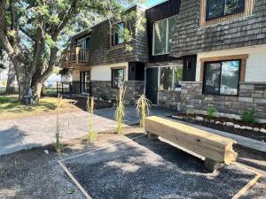 a wooden bench sitting in front of a building at One Bedroom Condo Near Whyte Ave Close to university in Edmonton