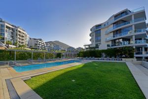 a swimming pool in front of a apartment building at Marina 107 in Cape Town