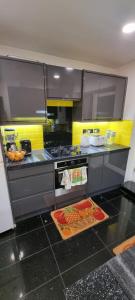 a kitchen with a stove and some food in it at Beautiful Rooms with free on street parking in Sydenham in Forest Hill