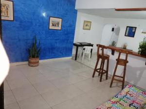 een kamer met een blauwe muur en een tafel en stoelen bij Casa lowcost relajación in La Dorada