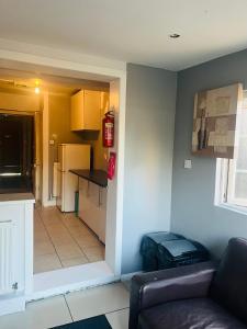 a living room with a couch and a kitchen at Lovely private room in Central London next to Hampstead, Camden, and Golders Green in London