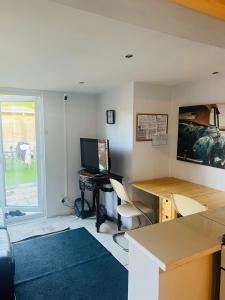 an office with a desk with a computer and chairs at Lovely private room in Central London next to Hampstead, Camden, and Golders Green in London