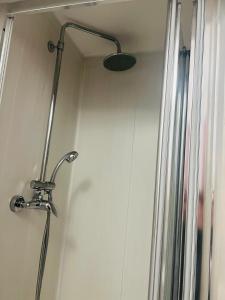 a shower with a shower head in a bathroom at Lovely private room in Central London next to Hampstead, Camden, and Golders Green in London