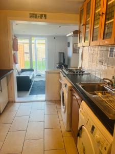 a kitchen with a sink and a dishwasher at Lovely private room in Central London next to Hampstead, Camden, and Golders Green in London