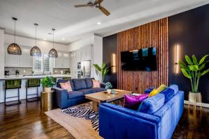 una sala de estar con 2 sofás azules y una mesa. en Urban Jungle Retreat in the HTX Skyline, en Houston