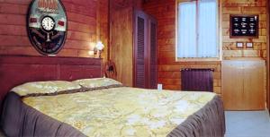 a bedroom with a large bed in a wooden room at Agriturismo Il Mio Casale in Monte Colombo