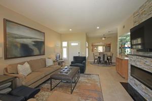 a living room with a couch and a fireplace at DL831 - Desert Falls Circle in Palm Desert