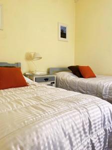 梅塞德斯的住宿－Duplex Reencuentro，一间卧室设有两张床和一张桌子上的台灯。