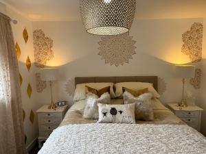 a bedroom with a bed with pillows on it at Ty Cwm - Cwmcarn Valley House in Cwmcarn