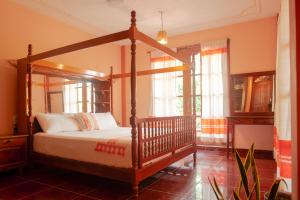 a bedroom with a canopy bed in a room at Casona H in Puerto Escondido