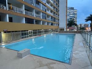 a large swimming pool in front of a building at GARVEY PARK in Brasilia