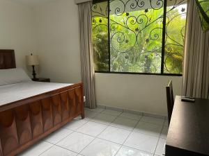 a bedroom with a bed and a stained glass window at Casa Pamplona in San Salvador