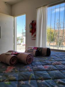 a bedroom with a bed with two pillows on it at Luna Alojamiento Temporario in Puerto Madryn