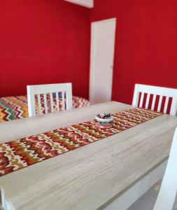 a dining room table with two chairs and a table with at Luna Alojamiento Temporario in Puerto Madryn