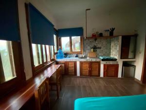 a kitchen with wooden cabinets and a counter top at Estudio con vista al mar, AC, WIFI Starlink, Parking in San Agustinillo