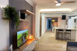 ein Wohnzimmer mit einem TV an der Wand in der Unterkunft Piso moderno a 15 minutos andando del centro in Huelva