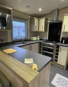 a kitchen with a counter and a stove top oven at The Fairways Hideaway - Northumberland in Newbiggin-by-the-Sea