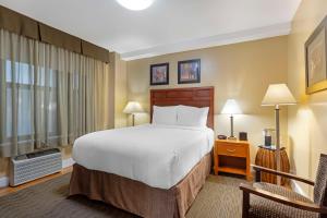 une chambre d'hôtel avec un lit et une chaise dans l'établissement Best Western Plus Hospitality House Suites, à New York