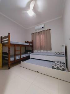 a room with two bunk beds and a ceiling at Casa de Temporada Maju - Olímpia - SP in Olímpia