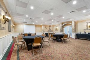 a conference room with tables and chairs and a whiteboard at Best Western Plus Westbank in Harvey +47 photos