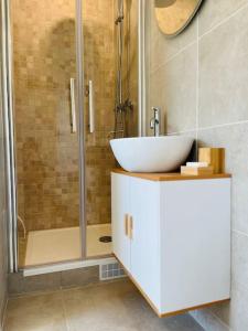 a bathroom with a sink and a shower at Maison Bobochic parking et jardin by Art de Voyager in Étretat +11 photos