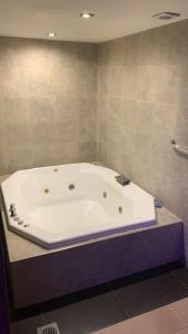 a large white bath tub in a bathroom at San Isidro Suite in Las Heras