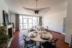 a living room with a table and chairs at Luxury Apart' MONS City Center with Terrace in Mons