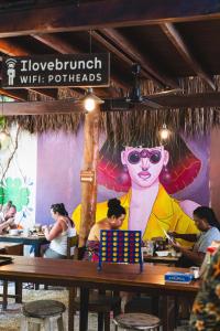 a group of people sitting at tables in a restaurant at Tunich Jungle Cabañas in Tulum